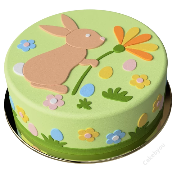 Egy kész, zöld alapú húsvéti torta nyuszival és virágokkal.